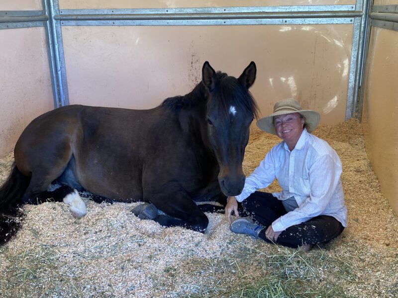 Kate Flaherty in stall with her horse.